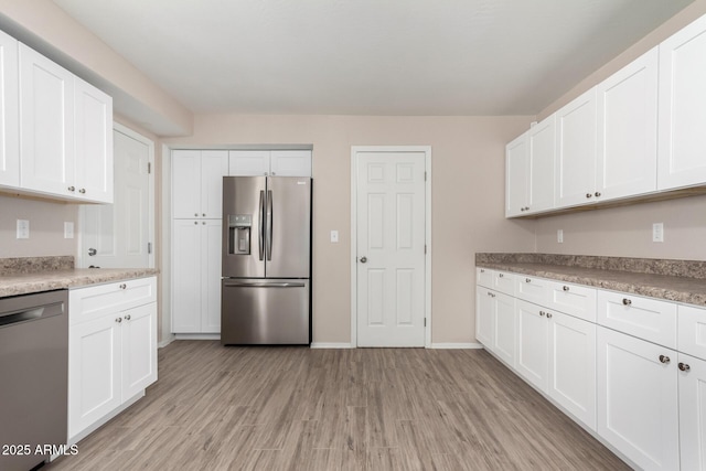 9803 N 40th Dr, Phoenix, AZ 85051 - kitchen featuring stainless steel appliances, light wood-type flooring, white cabinets, light countertops, and baseboards