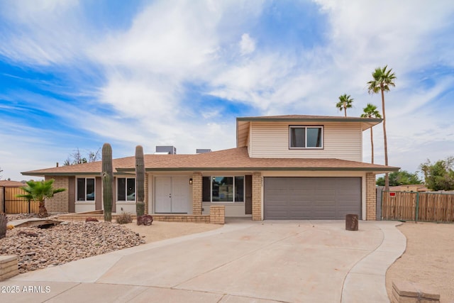 9803 N 40th Dr, Phoenix, AZ 85051 - view of front facade featuring a garage, brick siding, driveway, and a shingled roof