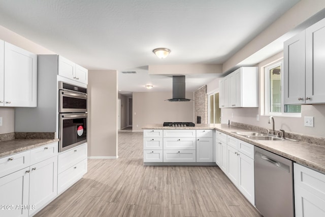 9803 N 40th Dr, Phoenix, AZ 85051 - kitchen featuring extractor fan, a sink, appliances with stainless steel finishes, a peninsula, and white cabinets