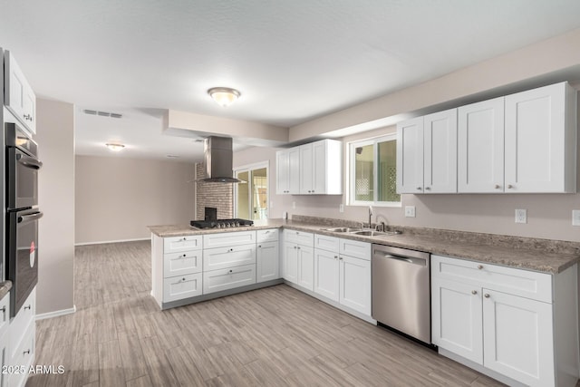 9803 N 40th Dr, Phoenix, AZ 85051 - kitchen featuring appliances with stainless steel finishes, wall chimney exhaust hood, a sink, a peninsula, and white cabinets