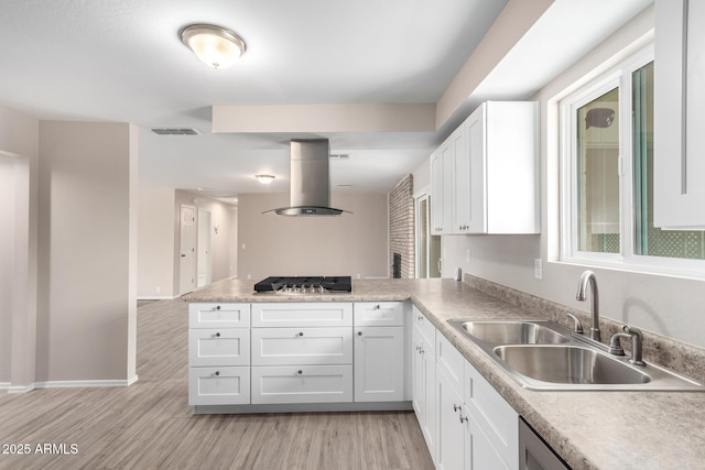 9803 N 40th Dr, Phoenix, AZ 85051 - kitchen with island range hood, a sink, a peninsula, stainless steel gas cooktop, and light wood-style floors