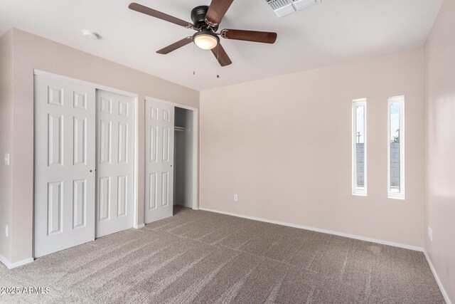 9803 N 40th Dr, Phoenix, AZ 85051 - unfurnished bedroom featuring multiple closets, carpet, baseboards, and ceiling fan