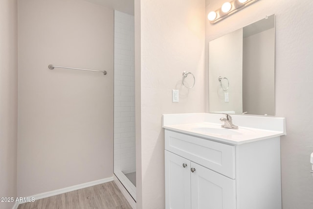 9803 N 40th Dr, Phoenix, AZ 85051 - full bathroom with vanity, wood finished floors, a tile shower, and toilet