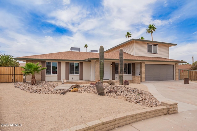 9803 N 40th Dr, Phoenix, AZ 85051 - view of front of home featuring concrete driveway, an attached garage, a porch, roof with shingles, and brick siding