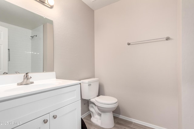 9803 N 40th Dr, Phoenix, AZ 85051 - full bathroom featuring toilet, vanity, wood finished floors, and baseboards