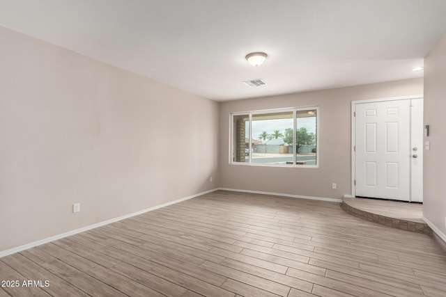 9803 N 40th Dr, Phoenix, AZ 85051 - spare room with light wood-type flooring and baseboards