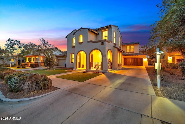 mediterranean / spanish-style house with a garage