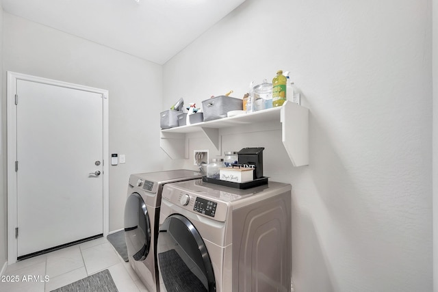 washroom with light tile patterned flooring and washer and clothes dryer