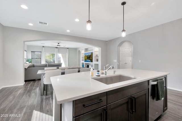 kitchen with ceiling fan, pendant lighting, stainless steel dishwasher, sink, and hardwood / wood-style flooring