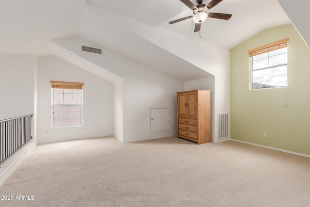 additional living space with visible vents, light carpet, and lofted ceiling