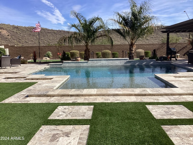 view of swimming pool with a patio and a lawn