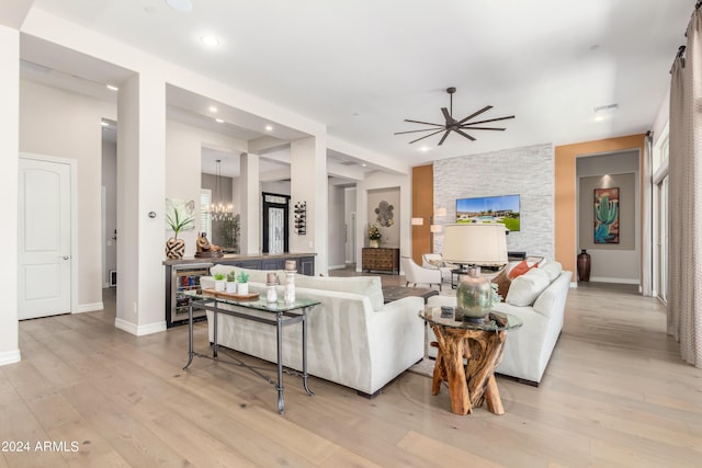 living room featuring wine cooler, ceiling fan, and light wood-type flooring