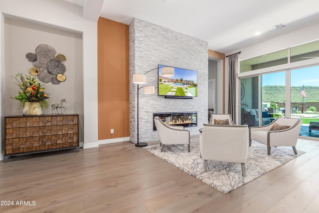 living room with a fireplace and wood-type flooring