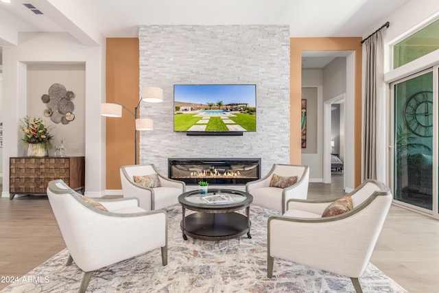 living room with a fireplace and hardwood / wood-style flooring