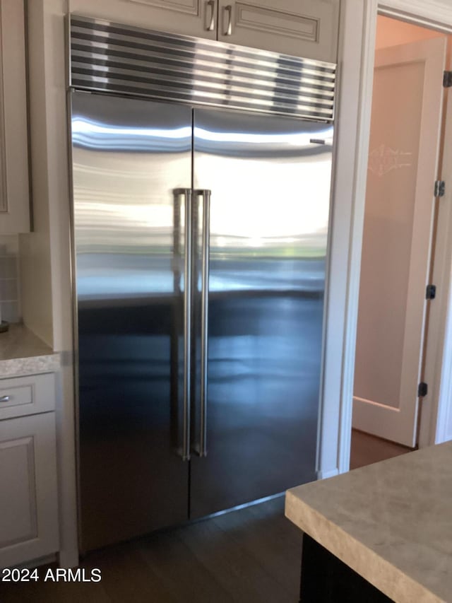 room details with decorative backsplash and stainless steel built in refrigerator