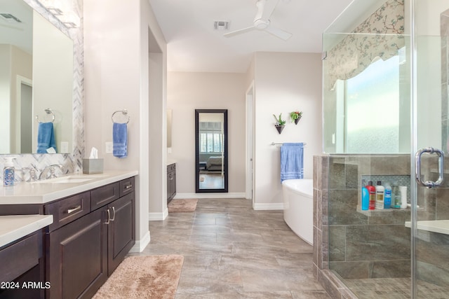 bathroom featuring vanity, separate shower and tub, and ceiling fan