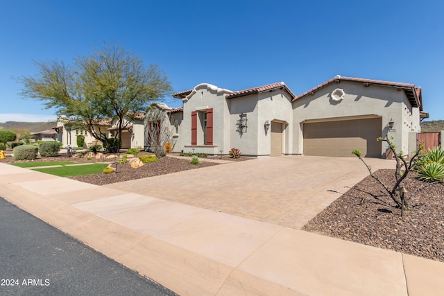 mediterranean / spanish-style home with a garage