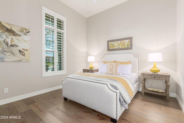 bedroom with hardwood / wood-style flooring