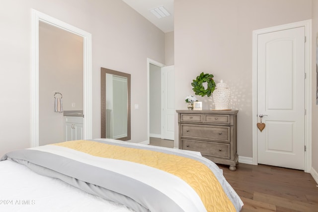 bedroom featuring hardwood / wood-style floors and ensuite bath