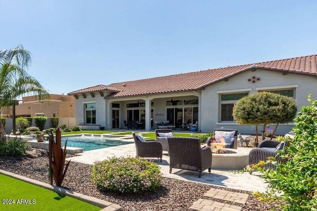 view of pool featuring a patio area and an outdoor living space with a fire pit