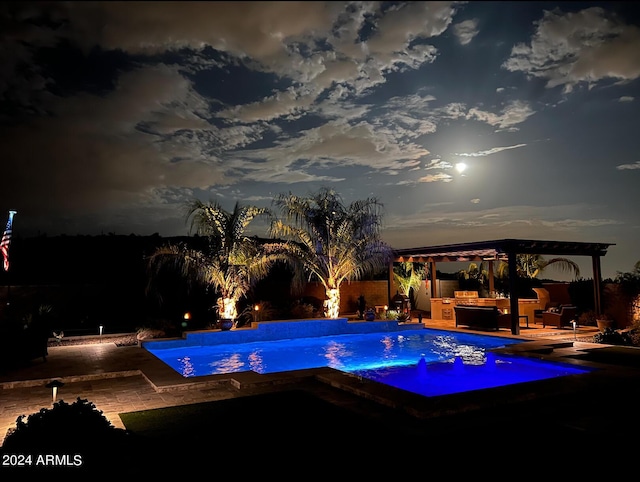 pool at dusk with area for grilling, a patio area, and a jacuzzi