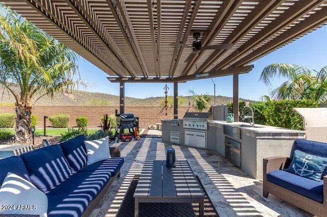 view of patio / terrace with a pergola, a grill, outdoor lounge area, and an outdoor kitchen