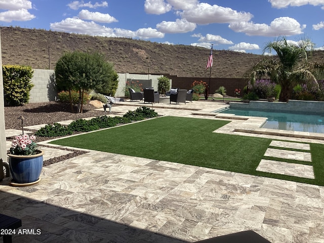 view of yard with a patio area and a fenced in pool