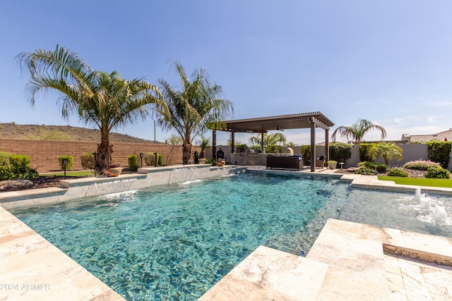 view of swimming pool featuring pool water feature and a patio