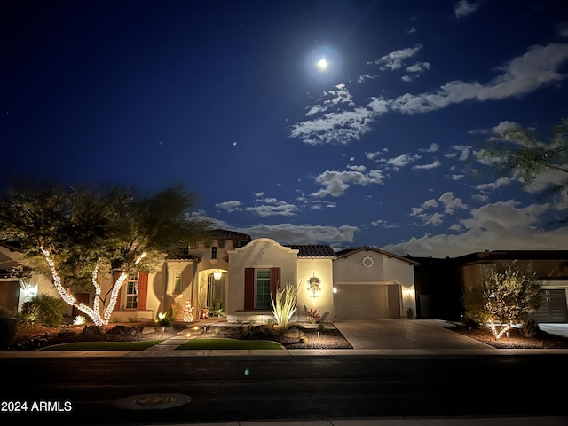 view of front of home with solar panels and a garage