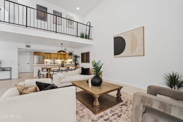 7409 E Pleasant Run, Scottsdale, AZ 85258 - living room with a towering ceiling, baseboards, light tile patterned floors, and recessed lighting