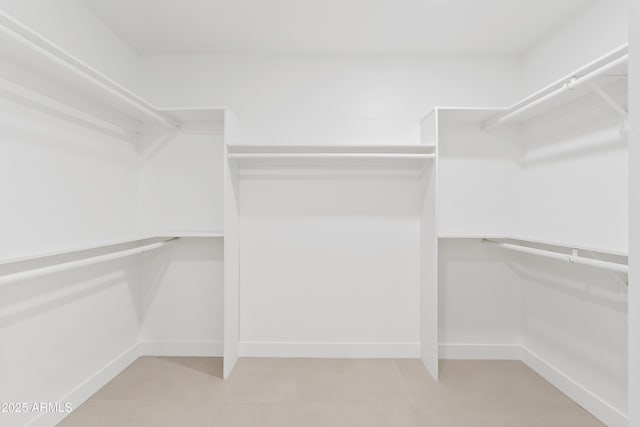 7409 E Pleasant Run, Scottsdale, AZ 85258 - walk in closet with light tile patterned floors