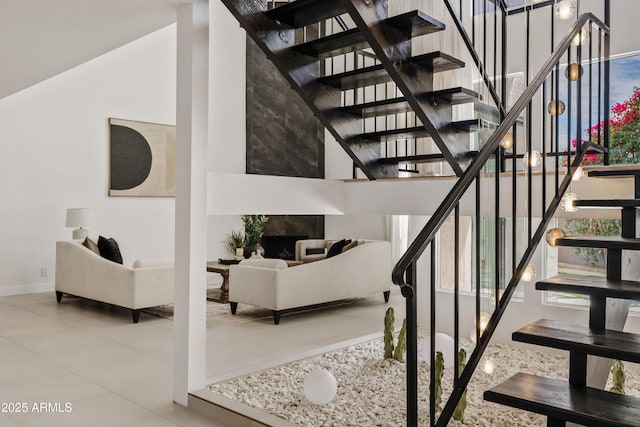 7409 E Pleasant Run, Scottsdale, AZ 85258 - stairway featuring tile patterned flooring, baseboards, and a high ceiling