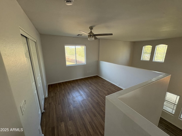 unfurnished room featuring dark hardwood / wood-style flooring and ceiling fan