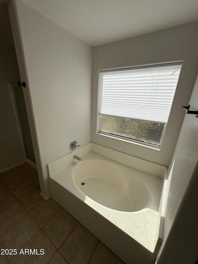 bathroom featuring a washtub and tile patterned floors