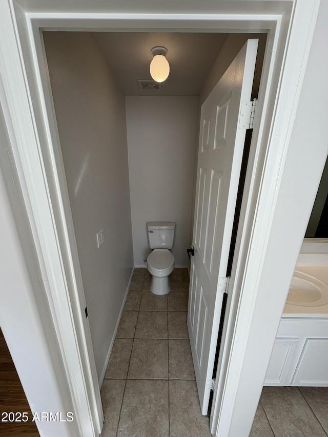 bathroom with tile patterned floors and toilet