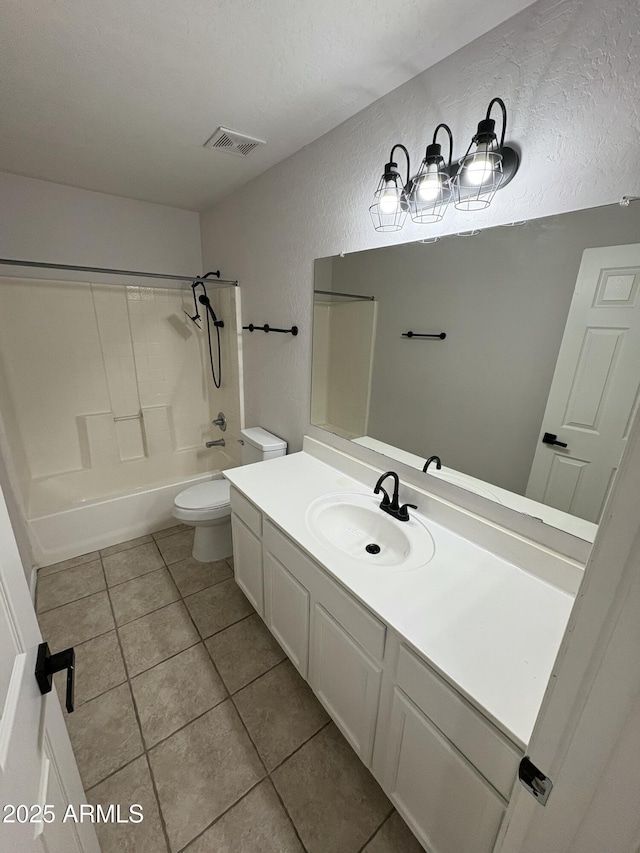 full bathroom featuring tile patterned floors, a textured ceiling, toilet, and tub / shower combination