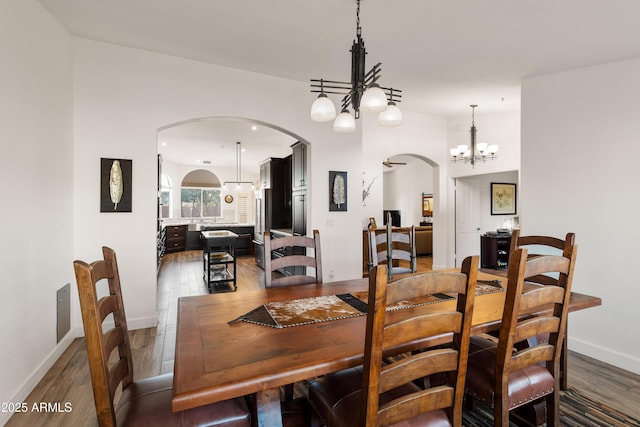 dining area featuring dark hardwood / wood-style floors and a notable chandelier