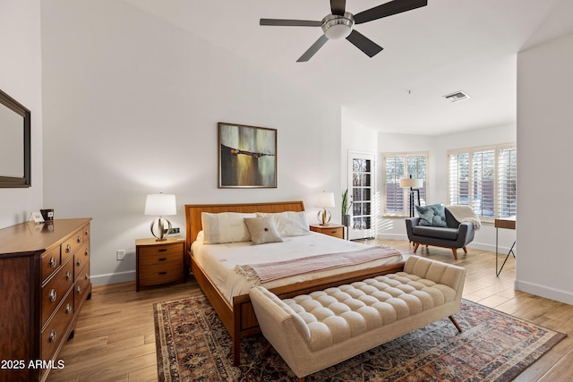 bedroom featuring ceiling fan, lofted ceiling, and light hardwood / wood-style flooring