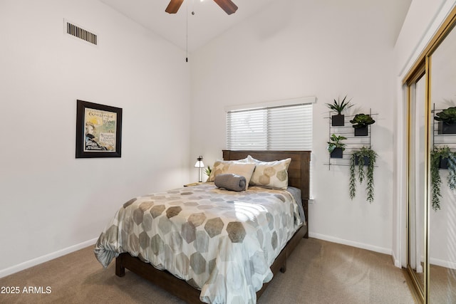 carpeted bedroom featuring ceiling fan and high vaulted ceiling