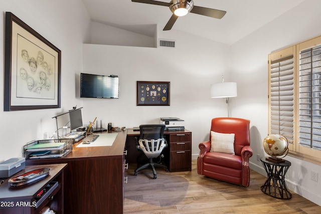 home office with vaulted ceiling, ceiling fan, and light wood-type flooring