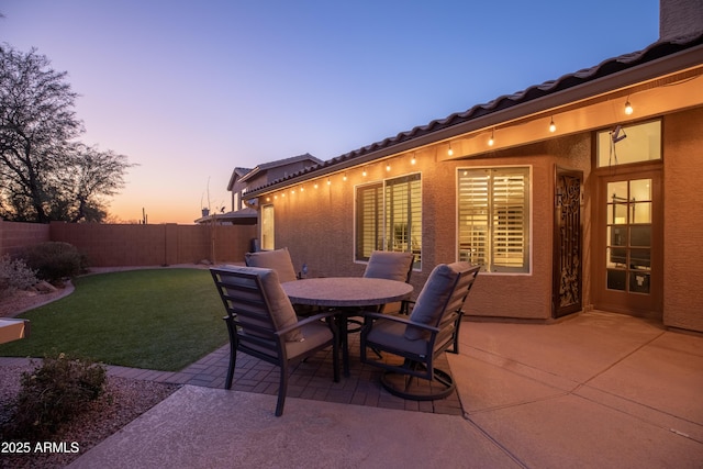 patio terrace at dusk with a yard