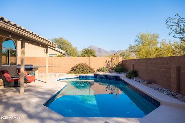 view of pool featuring a mountain view and a patio area