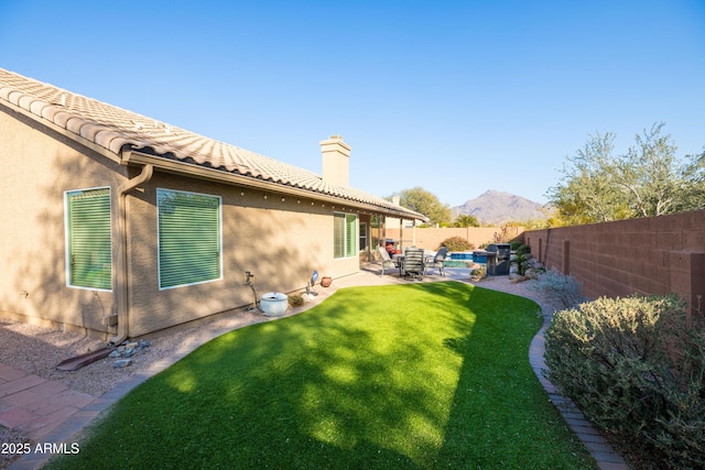 view of yard with a mountain view and a patio area