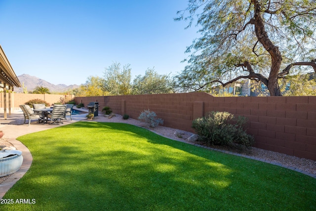 view of yard with a patio and a mountain view