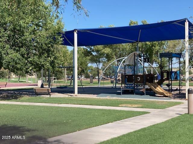 view of playground with a lawn