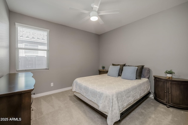bedroom with ceiling fan, baseboards, and light colored carpet