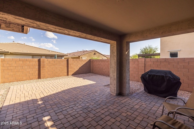 view of patio / terrace with grilling area and a fenced backyard