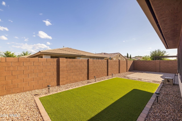 view of yard with a fenced backyard and a patio