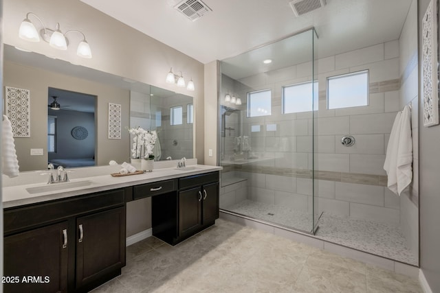 ensuite bathroom with ensuite bath, a sink, and visible vents
