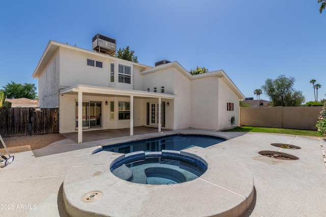 back of house featuring cooling unit, stucco siding, a fenced backyard, and a patio area